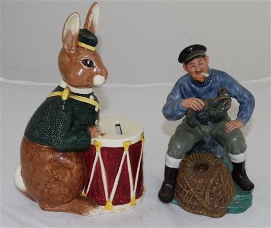 A Royal Doulton Bunnykins bank and a figure The Lobster Man